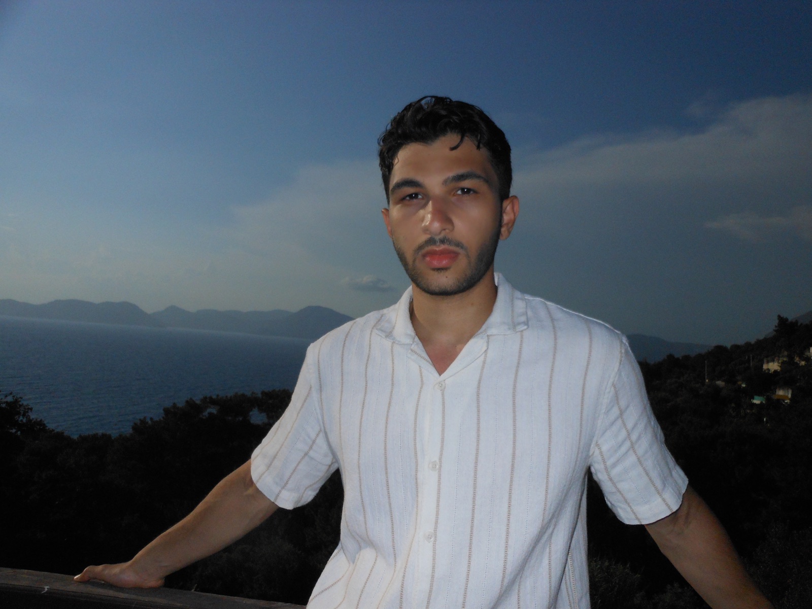 Yaseen Tolba overlooking the water at dusk